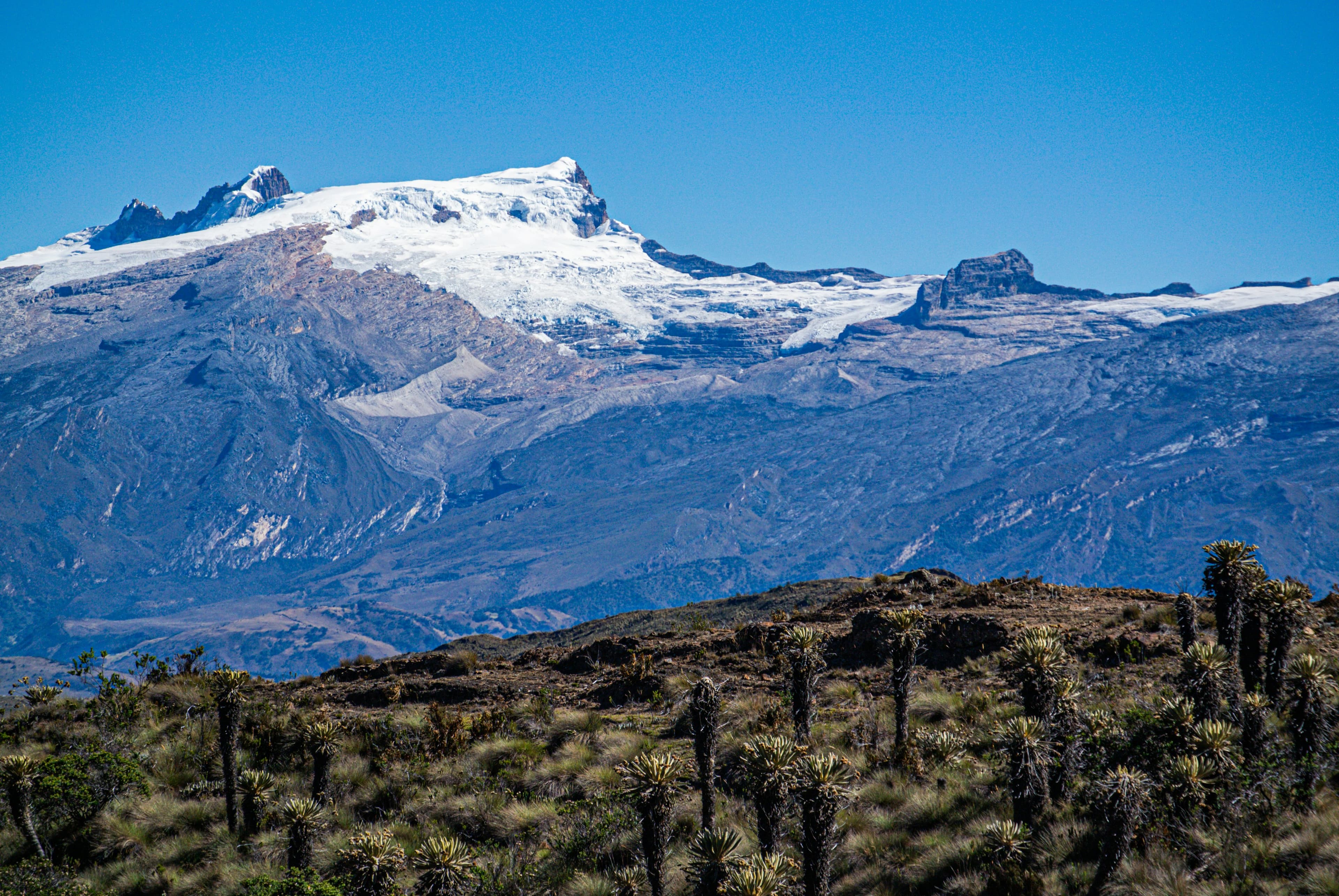 Snow-capped mountain range under a clear blue sky, Sierra Nevada del Cocuy, Colombia"